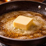 Pezzo di burro che si sta sciogliendo in padella